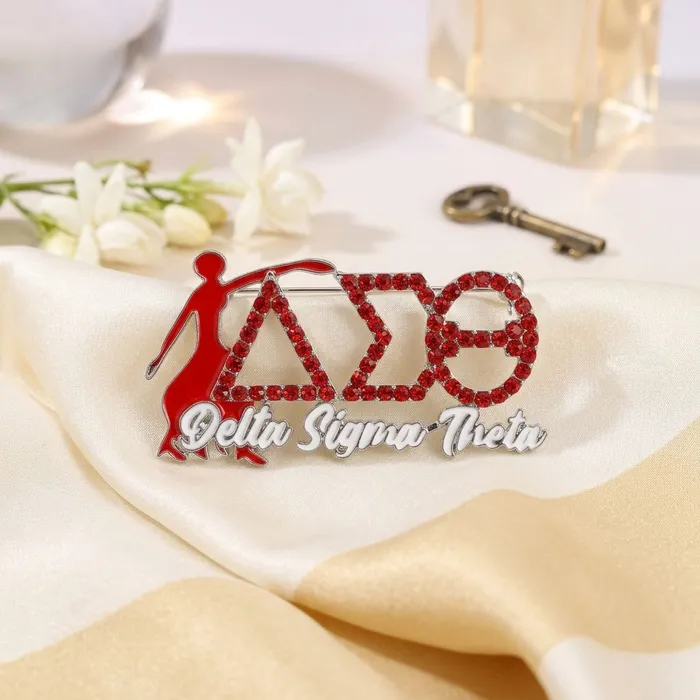 DST Fortitude brooch with red enamel Lady Fortitude figure and crimson rhinestone DST letters