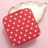 Red and white jewelry case with polka dot perfect for travel with zipper closure