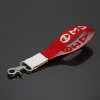 DST wristlet strap in red canvas with white embroidered DST letters and silver swivel hook