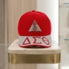 DST baseball cap in crimson red with red and clear rhinestone brim and rhinestone Delta triangle