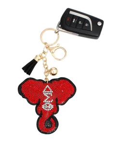 DST elephant keychain with gold-tone elephant head, red and clear rhinestones, and black tassel