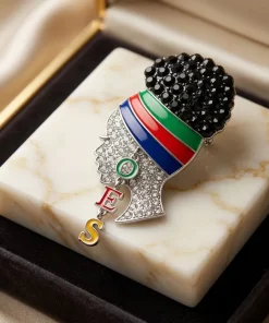 OES lady profile brooch with black rhinestone high puff, striped enamel headwrap, and dangling OES letters