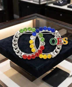 OES double circle brooch with enamel OES letters and multicolor rhinestone interlocking rings